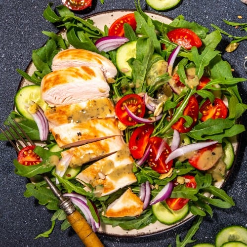 Grilled Chicken Over Mix Green.