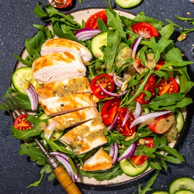 Grilled Chicken Over Mix Green.